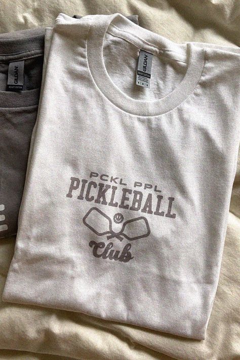 Pickleball t-shirt for pickleball people who love the sport. Pckl Ppl Co also sells pickleball stickers, pickleball hats, pickleball tank-tops and more. See you on the courts and catch these drops :) Pickleball Aesthetic, Pickleball Shirts, Pickleball Shirt, Lucky Me, Pickle Ball, Club T Shirt, Clothing Designs, Teacher Outfits, Garage Sale