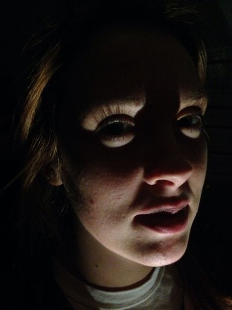 I took this picture of my roommate, with lighting from below her body. The lighting created a mask on her face which shows that she has depth, but hides her true personality with a mask from those who she doesn't know. The lighting in this picture makes it more stunning, dramatic, and intriguing. Scary Lighting Reference, Face Lit From Above, Computer Light On Face, Bright Light On Face Reference, Lighting From Below, Light From Below, Glowing Eyes In The Dark, Ominous Lighting Face, Intense Lighting