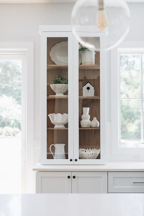 Stained oak shelves inside a glass-front china cabinet add a warm farmhouse touch styled with white ceramic decor. Glass Cabinets Display Ideas, Kitchen Glass Cabinets Display Ideas, Kitchen Glass Cabinets Display, Kitchen Glass Cabinet, Kitchen Glass Cabinets, Kitchen Cabinet Display, Glass Front Kitchen Cabinets, White China Cabinets, Glass Kitchen Cabinet