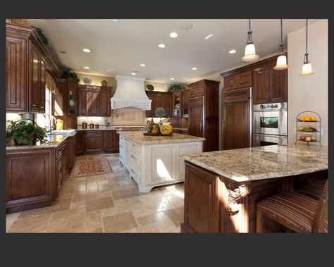 Richly detailed U-shaped kitchen centers dark wood cabinetry around large, white painted wood island with beige marble counters all around. Dark Brown Kitchen Cabinets, Dark Wood Kitchen Cabinets, Brown Kitchen Cabinets, Dark Wood Kitchens, Dark Wood Cabinets, Brown Cabinets, Black Kitchen Cabinets, Dark Kitchen, Kitchen Cabinets Decor