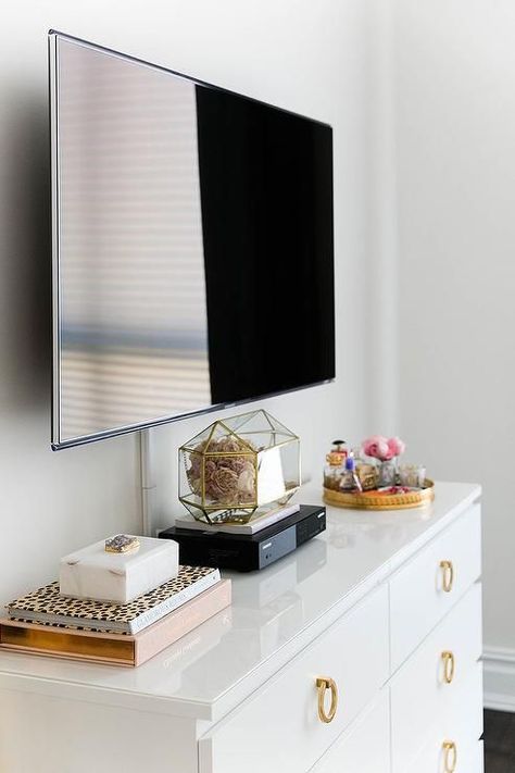 Chic bedroom features a flatscreen TV atop a white Ikea Malm Dresser adorned with gold ring hardware. Livingroom Table, Ikea Malm Dresser, Dresser With Tv, Tv In Bedroom, White Dresser, Bedroom Dresser, Trendy Bedroom, Dresser Decor, Bedroom Dressers