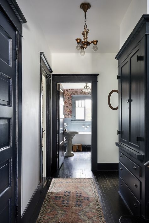 An L.A. Craftsman Restoration That Left the Good Stuff—Breadbox Included Black Trim White Walls, Moody Hallway, Craftsman House Interior, Black Trim Interior, Whimsigoth Home, White Craftsman, Art Deco Cottage, Craftsman Interior Design, Painted Trim