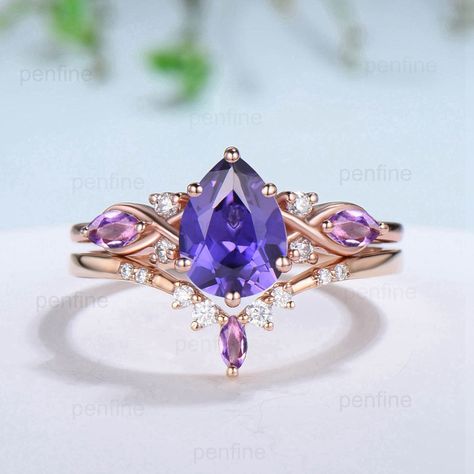 Elegant Pear Shaped Purple Sapphire Ring Set Vintage Unique Infinity Purple Crystal Engagement Ring Marquise Amethyst Wedding Proposal Gift ≫≫ Item Details  Make every ring to order, all rings are handmade in the United States.  Metal: Solid 10K & 14K & 18K Gold  Gold Color: Rose gold, Yellow gold, White gold Engagement Ring: 6x8mm pear cut lab purple sapphire About 1.25 carat Accent stone: 2pcs 4x2mm marquise cut natural amethyst and 4pcs 1.5mm round moissanite Matching band: Moissanite and ame Wedding Ring With Purple Stones, Elegant Purple Wedding Ring, Mystical Amethyst Promise Ring, Crystal Ring, Purple Sapphire Engagement Ring, Purple Ring, Purple Mystical Jewelry Ring, Purple Engagement Ring, Fairy Engagement Ring Amethyst