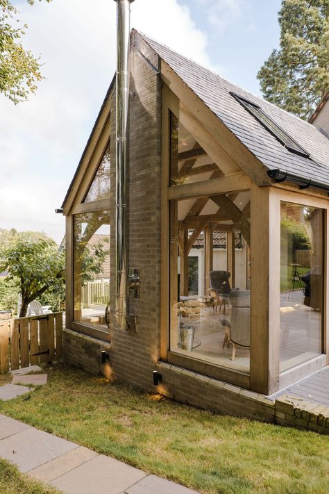 We are thrilled to present our recently completed Green Oak Frame Extension in Ceres, Fife. The oak frame design allowed us to incorporate an abundance of glass, not only flooding the space with natural light but also seamlessly connecting the indoors with the outdoors, bringing the surrounding trees right into the heart of the extended house. The weathered wood exterior also complements the existing harling of the house beautifully. Grand Designs Houses Uk, Timber Framed Extension, Country House Extension, Oak Frame Extension, Red Sandstone House, Greenhouse Attached To House, Retirement Cottage, Timber Frame Extension, Grand Designs Houses