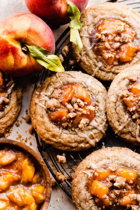 Peach Cookies are chewy, crisp-edged, cinnamon-spiced cookies filled with a quick stovetop peach filling, topped with a brown sugar crumble, and finished with a vanilla glaze. These summery cookies taste just like peach cobbler in cookie form. Bake these during peach season, and they'll be everyone's new favorite cookie! Peach Cobbler Cookies, Cobbler Cookies, Stephanie Simmons, Peach Filling, Spiced Cookies, Peach Cookies, Vanilla Glaze, Cookie Spread, Spice Cookies