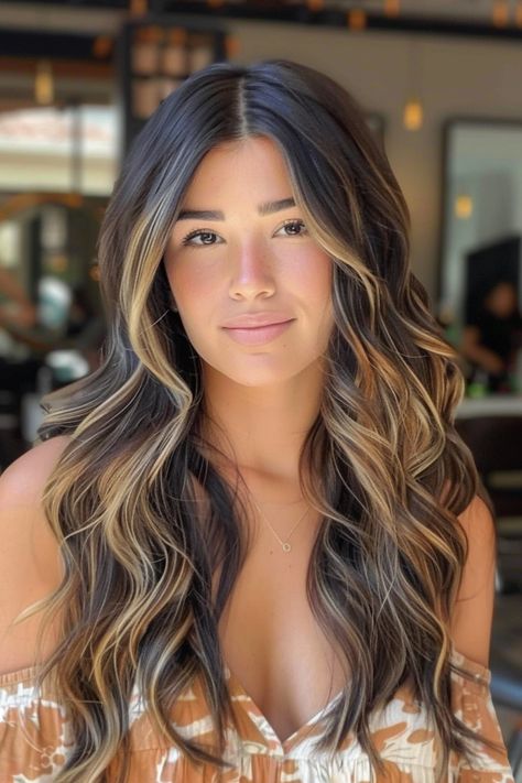 Young woman with long, wavy hair featuring blonde highlights, wearing an off-shoulder top in a well-lit indoor setting. Hair Color Ideas For Brunettes With Highlights And Lowlights, Dark Hair With Lowlights Balayage, Brunette Hair With Blonde Highlights And Lowlights, Wedding Hair Color Ideas, Wedding Hair Color, Dark Hair With Lowlights, Dark Hair With Blonde Highlights, Dark Hair With Blonde, Blonde Chunks