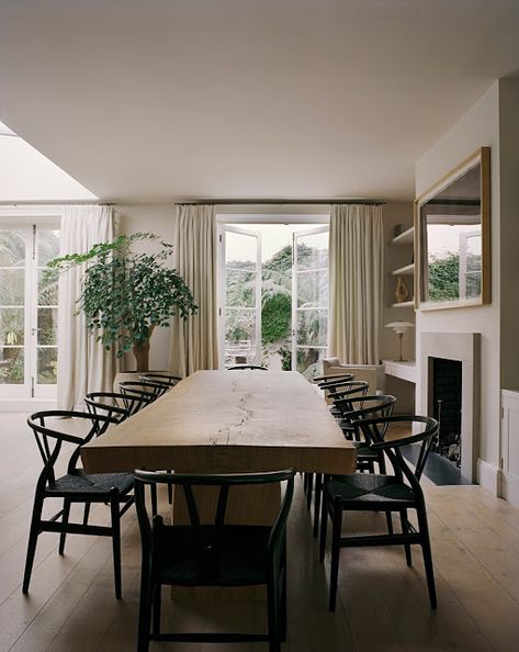 light wood live edge dining table with black thonet chairs, floor to ceiling neutral curtains with black curtain rods, indoor tree // fort & field Wishbone Chair Dining, Hill Villa, Rose Uniacke, Timeless Interiors, London Flat, London House, Oak Table, Dining Room Inspiration, Interiors Design