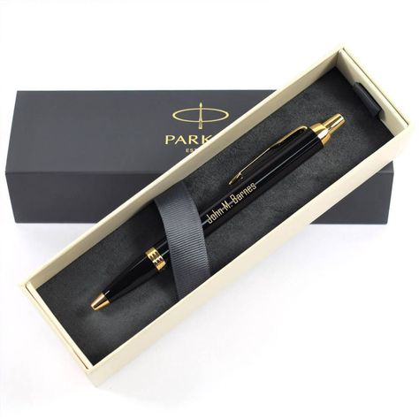 This Personalised Parker IM Black With Gold Trim Ballpoint Pen would make a beautiful and thoughtful gift for a loved one. It features a glossy black lacquered metal barrel which gives the pen a luxurious weighty feel, gold coloured trims, the classic parker arrow pocket clip and it is presented in a stylish Parker gift box. Our Parker ballpoint pens come with blue ink as standard. A custom engraved gift is perfect for adding a personal touch to something special and would make an ideal Birthday, Christmas, Graduation, Anniversary and Wedding Gift. Each pen is expertly engraved with your name or message using the latest technology engraving machines. The engraving shows as a gold colour on this pen.  This pen comes with blue ink. Need a black ink? We also retail these (please see the link Parker Pens, Parker Pen, Metal Barrel, Pen Collection, Personalised Pens, Silver Paper, Pocket Clip, Pen Gift, Marking Tools