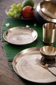 KANSA DINNERWARE #Ayurveda teaches us that eating & drinking from alkalinising metals like Kansa vessels has #health benefits. Kansa is an alloy of 85% copper and 15% tin. This traditional service ware, hand beaten by tribal craftsmen, has been used by generations for its anti-inflammatory & anti-septic properties. The benefits are clear & the vessels, beautiful. Enjoy the wisdom of heritage traditions for holistic well being. Discover the collection on our #WebBoutique . #EntertainInStyle Metal Dishes, Good Earth India, Puja Items, Indian Table, Pav Bhaji, Brass Items, Good Earth, Asian Inspiration, Woodworking Furniture Plans