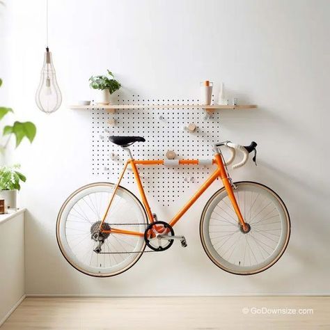 Designed as a pegboard, this rack offers a grid of holes that allow for flexible and adjustable bike storage. Bike Rack Apartment, Apartment Bike Rack, Indoor Bike Rack Apartments, Bicycle Display Ideas, Mudroom Bike Storage, Bike Wall Mount Apartment, Home Bike Storage, Indoor Bike Storage Ideas, Bicycle Storage Ideas Small Apartments