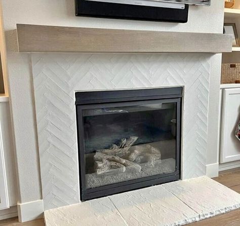 Herringbone Fireplace Surround Tile, White Tile Fireplace With Wood Mantle, Herringbone Tile Around Fireplace, Fireplace Chevron Tile, Marble Fireplace Wood Mantle, Schluter Tile Edge Fireplace, White Herringbone Tile Fireplace, Herringbone Backsplash Fireplace, Herringbone Tile Fireplace Surround