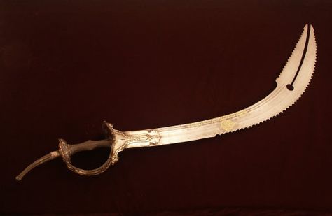 The Zulfiqar (late 1800s)Pictured above, a saber with a split point,  used in Persia (Iran). Made of Wootz steel, iron with silver inlay, brass, and organic adhesive. This ceremonial saber is highly unusual because of its cleft tip. This feature is found on a small number of swords.The split tip was a virtuoso achievement by a master craftsman Oracle Of Delphi, Hades And Persephone, Arm Armor, Islamic Design, Arabian Nights, Black Ops, Dragon Age, Character Costumes, Blacksmithing