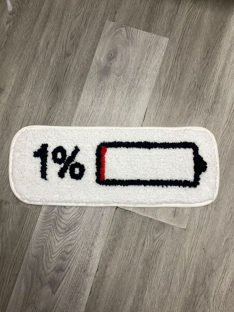 A tufted rug depicting a modern battery design displaying a 1% charge. This is great for a rug in a living room or a rug in a bedroom. This serves as great wall art decor or home decor living room. Bold Graphic Design, Gamer Room, Crochet Basket, Soft Texture, Tufted Rug, Walk On, Soft Textures, Thing 1, Rug