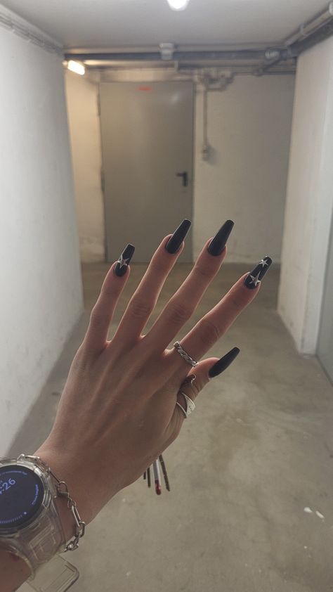 You can see a hand with long black nails and silver stars on the pinky and pointer finger Black Nails With Silver Stars, Nails With Star Charms, Star Nails Silver, Nails With Silver Stars, Nails Silver Black, All Black Nails, Black Nails With Silver, Long Black Nails, Nails With Silver