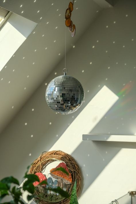 Need to fill your space with positive energy and a magical all natural light show.When placed in direct sunlight this Disco Ball will produce dancing sun reflection around your room.FAST SHIPPING - This item will deliver after the holidays1 Mirror Ball Per UnitCovered with Glass MirrorGreat for birthday parties, special events hall decorations and more!Perfect decor item you never knew you needed! Life is too short not to have fun with a disco ball in your space! Great gift for a friend who need Hanging Lights In Bedroom Ideas, Disco Ball On Ceiling, Disco Ball House Decor, Dorm Disco Ball, Disco Ball Interior Design, Mini Disco Ball Decor Bedroom, Disco Ball Living Room Decor, Disco Ball For Room, Disco Ball Apartment Decor