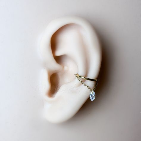 * Size in the main photo is 10mm conch Marquise CZ gold.  Available in the following finish.  Implant grade titanium in silver or gold.  Gauge: 16 or 18g Diameter: 6mm, 8mm, 10mm, 12mm Sold as single. I ship worldwide. Conch Earring Jewelry Silver, Hanging Helix Piercing, Cute Conch Piercing, Conch Piercing Aesthetic, Floating Helix Piercing, Piercing Combos, Conch Hoop Piercing, Conch Piercing Hoop, Conch Chain