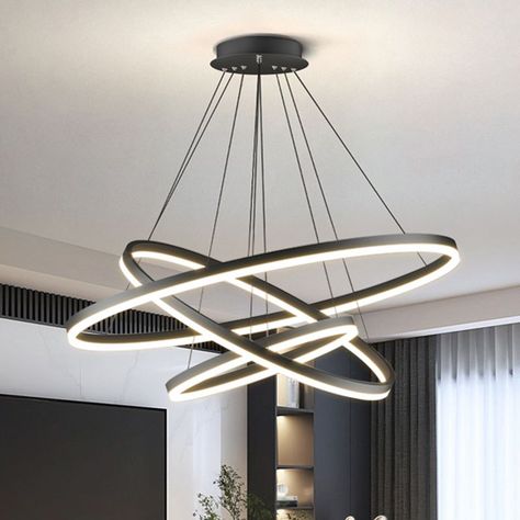 Crafted from a harmonious blend of solid metal and flawless acrylic, this light is designed to be attractive and long-lasting. Together, these high-quality materials create a long-lasting, visually striking accent to your living space. 
 The elegant, discreet black finish of our pendant lamp is achieved through a meticulous multi-ring stacking process and precision polishing, leaving the surface with a glossy, even black shine. This enduring black hue blends easily with any interior design, adding sophistication and modernity to your living space. 
 Our Arisha pendant light. Its mesmerizing design revolves around three interconnected rings, creating a truly one-of-a-kind visual masterpiece. The harmonious interplay of geometric shapes and gentle curves gives a touch of art to living spaces Pendant Light Set, Pendant Light Styles, Live Fit, Fluorescent Tube, Luminous Colours, Black Pendant Light, Modern Pendant Light, Lighting Store, Modern Pendant