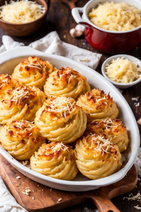 Duchess Potatoes with Garlic and Parmesan Recipe

Ingredients

- 2 pounds russet potatoes, peeled and cubed
- 1/2 cup unsalted butter, softened
- 1/2 cup heavy cream
- 1 cup grated Parmesan cheese
- 4 cloves garlic, minced
- 1 teaspoon salt
- 1/2 teaspoon black pepper
- 1/4 teaspoon nutmeg
- 2 large eggs
- Fresh parsley, for garnish (optional)

Full Cooking Instructions on... Peeled Potatoes Recipes, Duchess Potatoes Recipe, Potato Duchess, Dutchess Potatoes, Dauphine Potatoes, Potatoes Anna, Dauphinoise Potatoes, Stuffing Balls Recipe, Duchess Potatoes