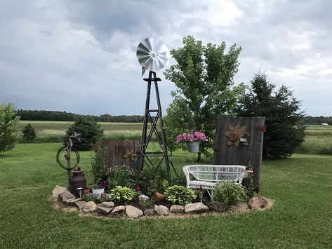 Small Windmill Yard Decor, Decorative Yard Windmills, Landscaping Around Windmill, Rustic Flower Beds In Front Of House Country Decor, Front Yard Landscaping Country, Front Yard Landscaping Rustic, Landscaping With Old Farm Equipment, Yard Windmill Garden Art, Windmill Yard Landscaping