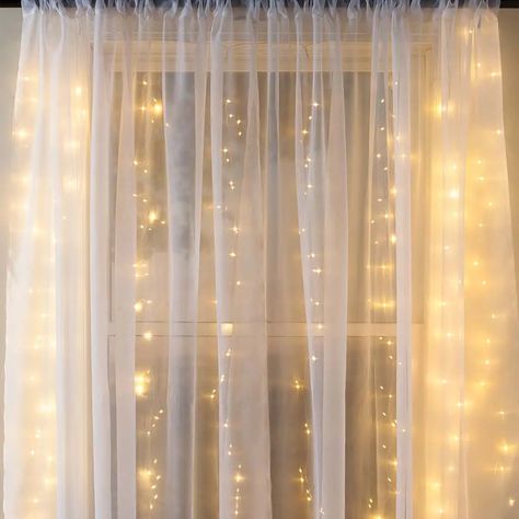 Twinkle outdoor lights and cozy indoor space – things that can set even a dull and gloomy mood. Isn’t it all you need when you come back home from a long exhausting day? Now is the time to swap your typical burned-out lightbulbs with fancy fairy curtain lights to get a welcoming vibe out of your space. Our hanging string lights can create a magical view in your room, making you want to snuggle in the bed with your partner. However, their usage isn’t limited to your indoor space. In fact, they ca Lighted Backdrop, Unique String Lights, Fairy Curtain Lights, Unicorn Rooms, Ramadan Vibes, Fairy Light Curtain, Hanging String Lights, Magical Light, Led Curtain Lights