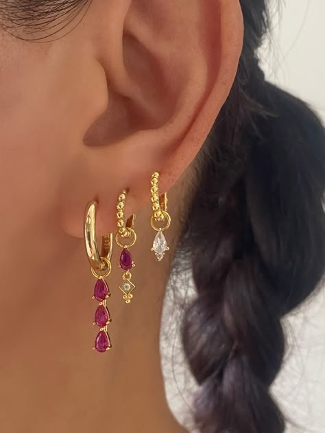 This gorgeous set comes with • 1 Pair of 3 Teardrop Pink charm with 17mm Hoop Material: 18k Gold plated on 925 sterling silver, AAAAA Cubic Zirconia • 1 Pair of Pink Teardrop charm with 15mm Princess Hoop Material: 18k Gold plated on 925 sterling silver, Cubic Zirconia • 1 Pair of Single Clear charm with 12mm Princess Hoop Material: 18k Gold plated on 925 sterling silver, AAAAA Cubic Zirconia • 1 Anett Gift Box HypoallergenicNickel free and Lead free 3 Earring Set, Colorful Gold Earrings, Earring Stack Ideas Gold, Pink Earring Stack, Cool Gold Earrings, Pink Earrings Aesthetic, Earring Stack Ideas, Pretty Stacks, Jewelry Colourful