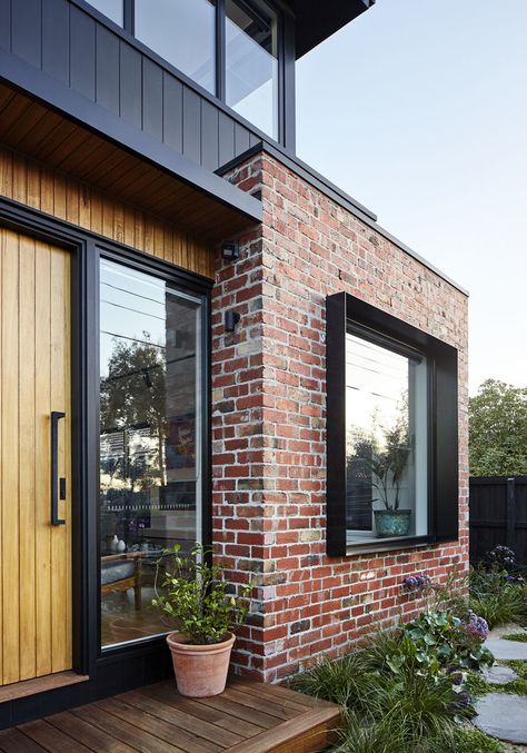 STEEL WINDOW BOX ON ENTRY WINDOW Surrounded by the recycled bricks is a deep steel window box detail that adds depth and shadow to this modern house facade. #Window #Bricks #ModernHouse Renovation Facade, Modern Brick House, Recycled Brick, House Cladding, Casa Country, Red Brick House, Modern House Facades, Brick Exterior House, Black Windows