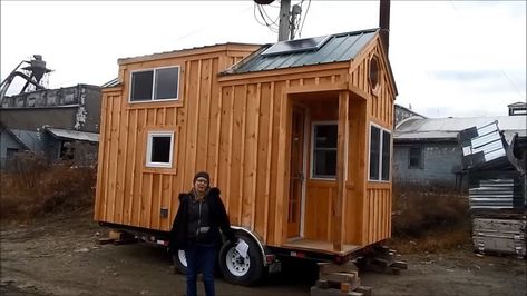 This is an 8×16 tiny house on wheels by Jamaica Cottage Shop. From the outside, you’ll notice a short trailer house with a gabled metal roof with loft dormers, a tiny front porch, and a … 8x16 Tiny House, Tiny House Porch, Small Houses On Wheels, Jamaica Cottage, Caravan Living, Mini Homes, Tiny House Cottage, Pre Fab Tiny House, Remote Locations