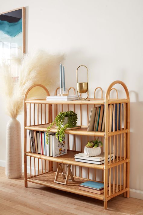 To create this exclusive Nylah bookcase, natural honey-hued rattan is bent and woven by artisans in Indonesia into gorgeously swooping curves. Featuring intricate details, this stunning piece's four open shelves are enclosed by an arched rattan back and sides, creating an airy yet sturdy shelving unit with warm boho style. #worldmarket #bookshelf Boho Nightstand Ideas, Bamboo Bedroom Furniture, Condo Makeover, Rattan Bedroom, Interior Design Per La Casa, 1st Apartment, Rattan Furniture, Living Room Inspo, Book Shelf