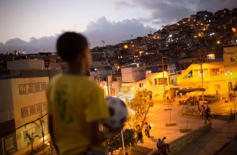 A young Brazilian footballer overlooking the favela in Rio de Janeiro Brazil Life, Street Football, Brazil Culture, The Beautiful Game, Summer Aesthetic, South America, Rio De Janeiro, Dream Life, At Night