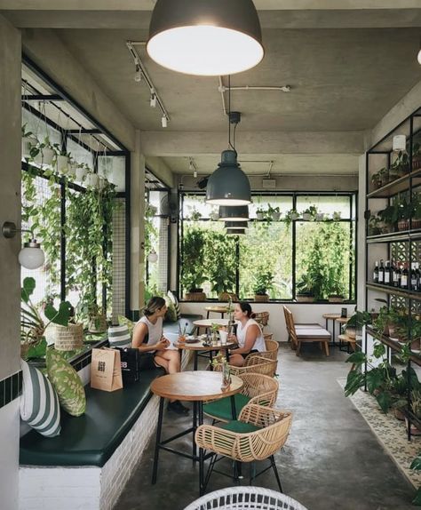 Coffee Shop With Plants Interior Design, Coffee Shop Plants Decor, Earthy Cafe Interior Design, Plant Cafe Interior, Cafe Plants Interiors, Coffee And Plant Shop, Greenhouse Coffee Shop, Indoor Garden Cafe, Coffee Shop With Plants