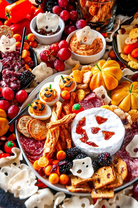 Create a spooktacular Halloween cheese board with Jack-o'-lantern brie, roasted red pepper hummus, ghost chips, and more! Perfect for adding a touch of festive fun to your gathering. Recipes for the homemade deviled eggs, hummus, and pumpkin bread rolls included! Ghost Chips, Pumpkin Bread Rolls, Halloween Cheese Board, Gathering Recipes, Halloween Cheese, Pepper Hummus, Spooky Snacks, Roasted Red Pepper Hummus, Red Pepper Hummus