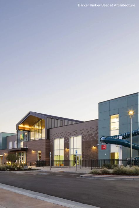 Located in Northglenn, Colorado, Northglenn Recreation Center offers the community a performing arts theater, swimming pools, senior center, and more for them to use. Max Compact Exterior HPL panels from Fundermax were combined with other woodgrain and plain color panels, giving the facade this sense of modernity through the natural material decor AF Patina. For more project images and information, visit: https://fundermax.us/projects/northglenn-recreation-center/ Recreation Center Design, Performing Arts Theater, Leisure Pools, Senior Center, Recreation Centers, Sims House Design, Theatre Arts, Community Center, Plain Color