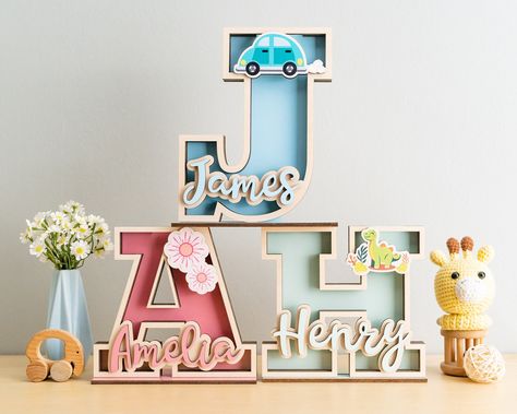 Welcome to the enchanting world of Baby Letter Bank, where imagination meets practicality! Our personalized name money banks are the perfect blend of charm and functionality, ideal for kids' birthdays, baby gifts, or christening celebrations. Crafted with love, these wooden name boxes make saving money a delightful adventure for little ones. These Coin Bank are 100% handmade with High Quality Plywood and Arcylic DETAIL: - Height:  + 7 inches ~ 17.5cm + 9 inches ~ 22.5cm + 11 inches ~ 27.5cm - De Custom Piggy Bank, Wooden Piggy Bank, Personalized Home Decor, Baby Letters, Kids Money, Nursery Decor Boy, Wooden Letter, Piggy Banks, Personalized Gifts For Kids