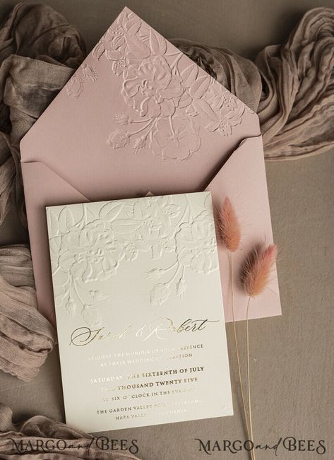 When it comes to setting the tone for your wedding day, nothing speaks more eloquently than a Fine Art Embossed Blind Blush Pink Gold Wedding Invitation. This exquisite invitation, adorned with delicate golden deboss roses and floral designs, exudes a sense of elegance and sophistication. For the free-spirited couple looking to add a touch of bohemian charm to their wedding, the Boho Ecru Debossed Invitation suite is the perfect choice. With its intricate debossed patterns and earthy tones, this Deboss Invitation, Floral Signage, Wedding Invitations Embossed, Elegant Wedding Invitations Luxury, Boho Wedding Invitations, Debossed Invitation, Wedding Invite Embossed, Wedding Invitations Beige And Gold, Wedding Invitations Nude Pink