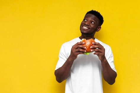 Photo pensive african american man in wh... | Premium Photo #Freepik #photo #hungry-man #unhealthy-food #eating-burger #man-eating Guy Eating, Eating Burger, Hungry Man, Big Burger, Man Eating, Big Burgers, African American Man, Food Eating, Eating Fast