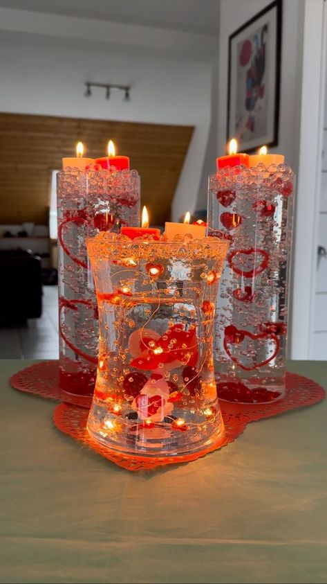 Beautiful Valentine's Day decoration | vase | Beautiful Valentine's Day decoration I put some decorative lights and jelly beads inside a vase to make a creative center piece! | By Cirqnamics | Facebook | Okay. Little gnome is submerging. Can you see his little face? Mhm. Okay here we go. One. Two. Three. Oh perfect. Cute. Oh no the little heart. Can you still see him? Yeah. Okay. That's fine then. I'm going to put this down gently so that the water doesn't spill out. I'm going to grab just like Valentine Centerpieces, Perfect Cute, Gel Beads, Decorative Lights, One Two Three, Water Beads, Valentines Day Decorations, Nice Things, Valentine Decorations