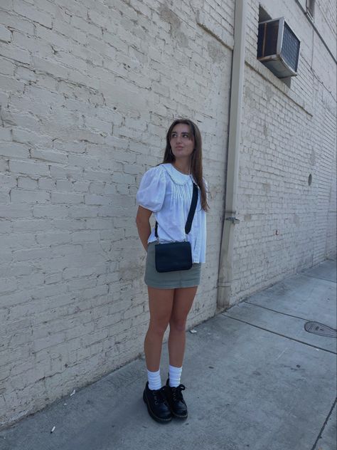 girl in dr martens, green cargo mini skirt and white ruffle shirt posing in front of white brick wall Brick Wall Photoshoot Ideas, Wall Photoshoot Ideas, Brick Wall Photoshoot, Wall Photoshoot, White Brick Wall, Downtown Aesthetic, Aesthetic Fit, Pic Inspiration, Aesthetic Fits