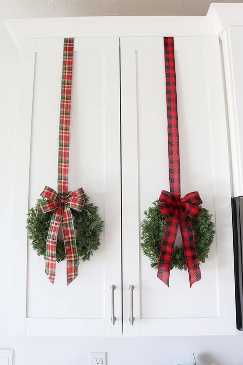 Hanging Wreaths With Ribbon, Kitchen Cabinet Wreaths, Wreaths On Cabinets, Christmas Wreaths On Kitchen Cabinets, How To Hang A Wreath On A Window, Cabinet Christmas Wreaths Diy, Hanging Christmas Wreaths On Kitchen Cabinets, Cabinet Wreath Kitchen Diy, Kitchen Cabinet Christmas Wreaths