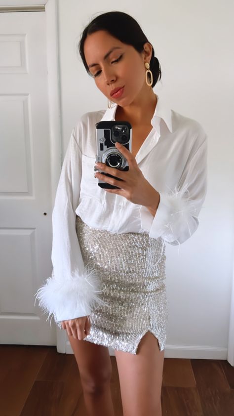 Feather trim blouse | sequined mini skirt | holiday outfit | holiday party outfits Sequin Skirt White Shirt, Mini Skirt Holiday Outfit, White Mini Skirt With Sequins For Party, Holiday Evening Mini Skirt With Sequins, Winter Mini Skirt With Sequins, Elegant White Sequined Mini Skirt, Glitz And Glam Party Outfit, Mini Skirt Outfit Night, Sparkly Skirt Outfit