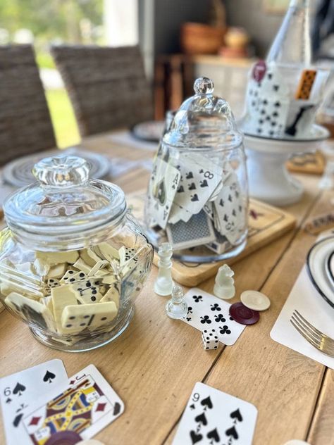 It's tablescape day for my dinner club and this month is all about game night. I have some winning game night party table setting ideas and inspiration to share with you. This table theme was so fun to create. I was able to scour my game closet at home and use playing cards, poker chips, dice, and a chess set to incorporate into my table setting. I picked up a few vintage game boards at a thrift store for a few dollars and a package of paper napkins with a game theme to complete my table. Board Game Centre Pieces, Diy Blackjack Table, Game Night Set Up, Poker Birthday Party Ideas, Board Game Night Ideas, Vintage Activities, Vintage Game Boards, Game Night Table, Game Night Decorations