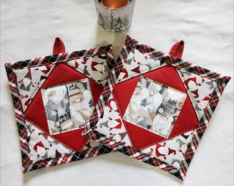 "Set of 2 quilted potholders or hot pads made from 100% cotton fabric - square-in-square design with red fabric, and gray/tan color-schemed gnomes, with black, white and red plaid-patterned binding. Backing is light gray fabric with happy gnomes on it. Handmade loop in matching red fabric to hang this item that can be used over the winter season or to decorate your Christmas table or kitchen. Dimensions are 7.5\" x 7.5\". The cotton fabric is quilted over insul-bright batting that helps protect Christmas Pot Holders, Quilted Hot Pads, Vintage Potholders, Christmas Potholders, Christmas Table Runner Pattern, Christmas Mug Rugs, Quilted Potholders, Christmas Pots, Potholder Patterns