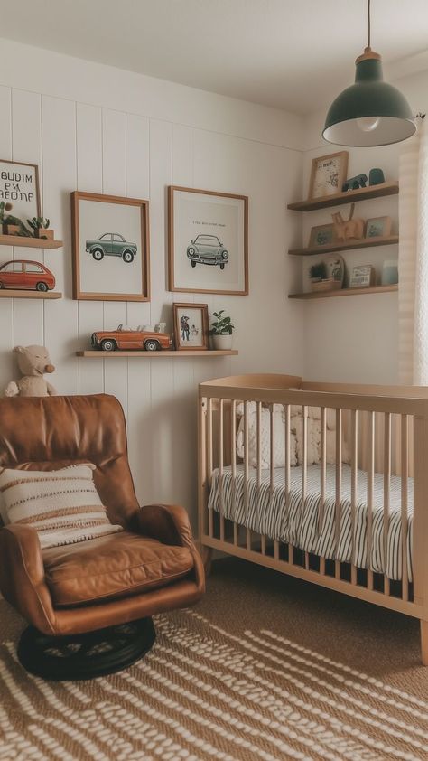 Cozy nursery with vintage car wall art, a leather armchair, and natural wood crib. Car Themed Nursery Vintage, Little Boy Car Room, Vintage Truck Nursery Theme, Vintage Car Themed Nursery, Classic Car Nursery, Dirt Bike Nursery Baby Boy, Baby Boy Nursery Car Theme, Nursery With Color, Car Nursery Ideas Boy