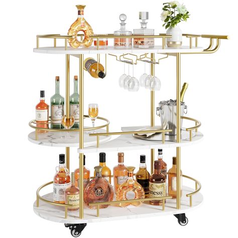 PRICES MAY VARY. Luxurious Appearance Design: The golden metal frame is supplemented by marble-grained wooden boards, giving the appearance of the bar cart a noble temperament. The elegant appearance also retains all the functions of ordinary gold rolling cart, which is both beautiful and practical. Large Storage Space: With three levels of storage space, the dimensions of 34.2”L x 15.7”W x 37”H provide sufficient storage space on each tier.Whether it's wine or after-dinner snacks, just put it o Home Bar Designs Luxury, Bar Cart Gold, Wine Cart, Bar Serving Cart, Gold Bar Cart, Cart With Wheels, Serving Cart, Home Bar Designs, Home Bar Furniture