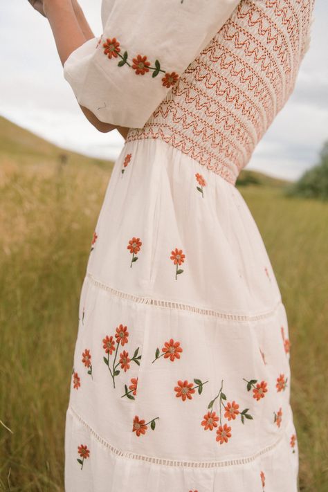 Our stunning Greta Dress is BACK in a classic midi-length! This beautiful fall dress is made of ivory cotton with rust floral embroidery, featuring a v-neckline with ruffle detailing, 1/2 length puff sleeves, and a tiered midi-length skirt with pockets. The pull-over style and smocked bodice provide a comfortable and flattering fit for all body types (hint hint: maternity friendly!). Complete with scalloped embroidery at the hem, this fully lined women's dress is both charming and functional. Tr Maternity Floral Dress, Spring Feminine Midi Maternity Dress, Fall Dress, Cute Dresses Modest, Dainty Floral Maternity Dress, Cotton Cottagecore Dress With Floral Embroidery, Flowy Floral Print Maternity Midi Dress, Beautiful Fall Dresses, Greta Dress