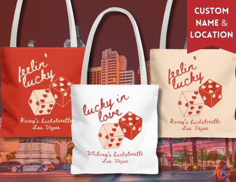 "Hey there, bride tribe! Get ready to hit the jackpot with our custom matching bachelorette tote bags - they're the perfect accessory for your Vegas adventure! For our leading lady, we've got the ultimate tote bag featuring \"Lucky in Love.\" It's the perfect way for the bride to stand out while carrying all her bachelorette essentials. And check this out: We've added her name and a spot for a custom location, making each tote extra special. Plus, there are two dice with hearts for eyes, adding a playful Vegas touch! But wait, the luck doesn't stop there! For the rest of us lucky ladies, our tote bags also say \"Feelin' Lucky,\" along with the bride's name and a spot for a custom location. It's a sweet reminder of our unforgettable Vegas getaway and our love for the bride-to-be. Whether yo Vegas Bachelorette Gift Bags, Vegas Goodie Bags, Las Vegas Gift Ideas, Dice With Hearts, Lucky In Love Bachelorette Party, Vegas Bachelorette Gifts, Bachelorette Goody Bag Ideas, Bachelorette Essentials, Vegas Bachelorette Party Favors