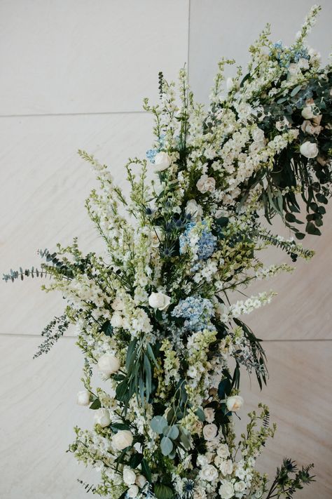 white and green with a hint of dusty blue makes for a dreamy arch. #weddingideas #weddingflowers #weddingphotography #weddinginspiration #weddingdecor #flowers #dustyblue Dusty Blue Arbor Flowers, Dust Blue Wedding Flowers, Dusty Blue Dark Green Wedding, White Green Blue Wedding Florals, Dusty Blue And Sage Green Wedding Arch, Dusty Blue And Sage Wedding Centerpieces, Green And Blue Wedding Bouquets, Safe Green And Blue Wedding, Sage Green And Blue Wedding Flowers