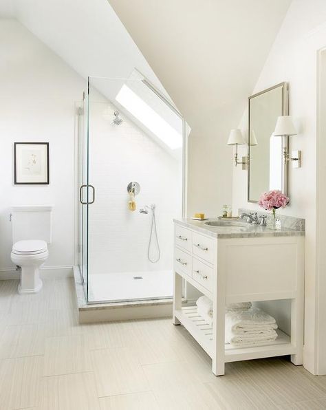 An en suite bathroom is filled with a white vanity with shelf topped with carrera marble, Restoration Hardware Hutton Single Washstand, placed under a polished nickel mirror illuminated by polished nickel sconces. Sloped Ceiling Bathroom, Low Ceiling Attic, Attic Shower, Attic Bathroom Ideas, Transitional Home Decor, Attic Bathroom, Bad Inspiration, Transitional Bathroom, Bathroom Ceiling