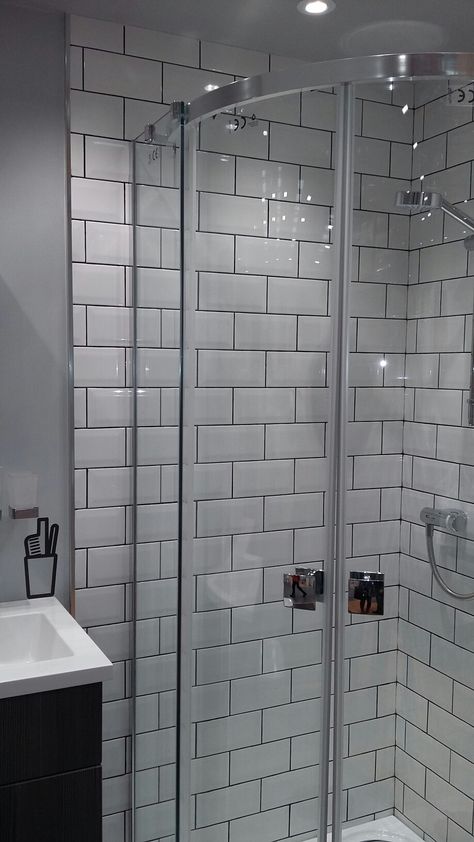 Metro tiles with dark grout. Grey walls. Shower cubicle. From B&Q Shower Cubicle Tile Ideas, Tiles With Dark Grout, White Tiles Black Grout, Shower Tiling, White Metro Tiles, Dark Grout, Tile Showers, Metro White, Shower Cubicle