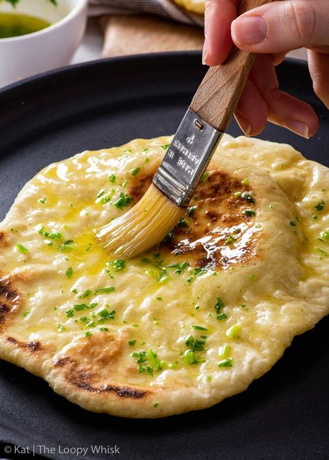 Brushing gluten free naan with melted butter and chopped parsley. Gf Naan, Naan Bread No Yeast, Gluten Free Naan Recipe, Gluten Free Naan Bread, Bread No Yeast, The Loopy Whisk, Loopy Whisk, Gluten Free Naan, Recipes With Naan Bread