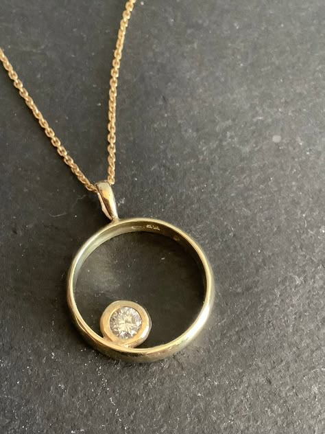 This was an 18ct gold diamond ring  But we converted it to a pendant  The  diamond is 0.25ct ,quarter carat . A very clean ,white ,bright top quality diamond,with no visible inclusions. Diamond 6mm diameter in its setting  the circle is 14ct gold , stamped 585.  Pendant 17mm diameter. Hanging on a  18" silver gilt chain  I have done a few of these and can convert your own ring if you are in uk  It's a lovely way to wear inherited engagement rings. Round Pendant Jewelry With Diamond Accents, Pendant Made From Wedding Ring, Reset Diamond Ring Into Necklace, Silver Diamond Necklace With Round Pendant In 14k Gold, Keepsake Diamond Pendant Jewelry, Diamond Circle Necklace, Round Diamond Pendant, Diamond Pendants Designs, Diamond Pendants